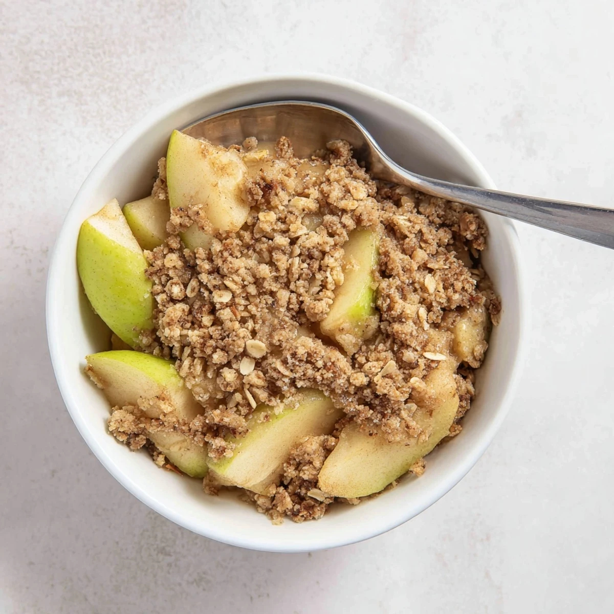 Rustic Apple Crumble baking dish with bubbling cinnamon apple filling and golden crumble topping, ready to serve at a casual gathering.
