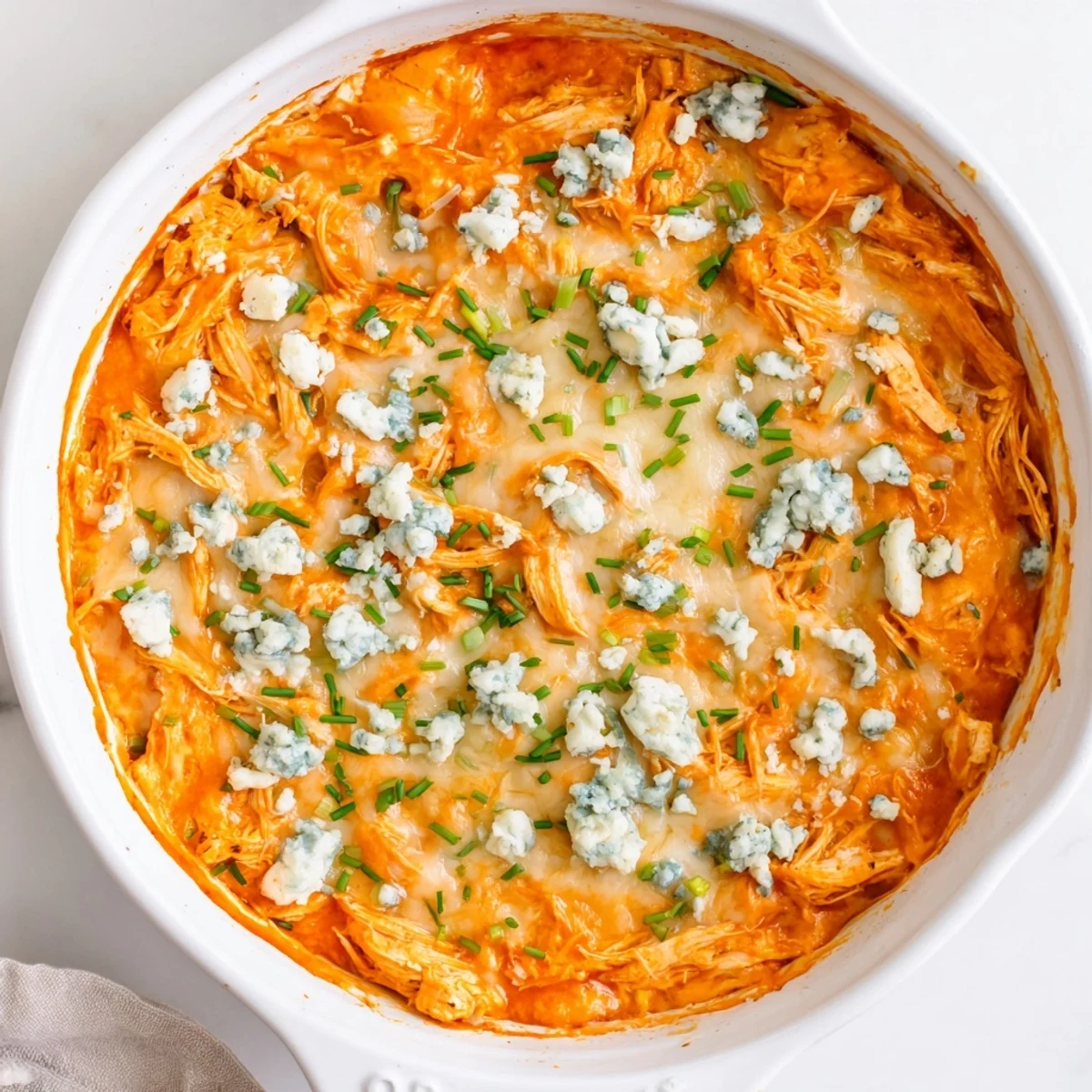 Sizzling hot Buffalo Chicken Dip in a baking dish, ready for a party or game day.