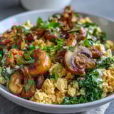 Savory Scrambled Tofu Breakfast Bowl garnished with fresh parsley and avocado, perfect for a wholesome vegan morning meal.