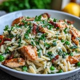 Tender chicken and orzo simmered in lemon-garlic broth with sweet peas, finished with Parmesan and fresh parsley.  