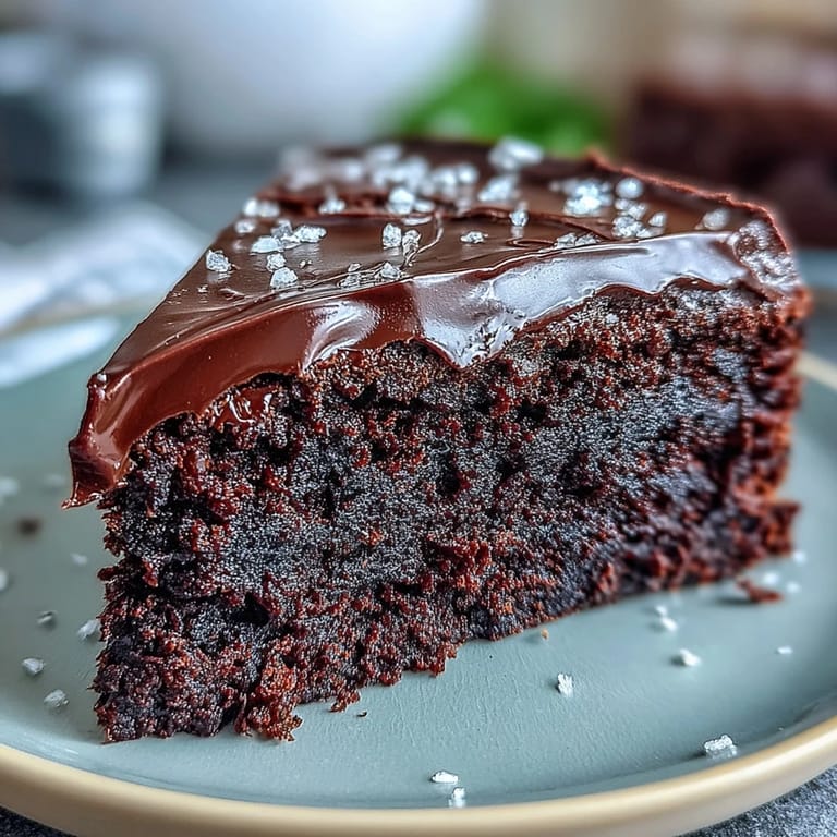 Freshly baked Easy Chocolate Fudge Cake with a glossy chocolate glaze, garnished with fresh berries and ready to serve.