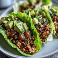 Juicy turkey taco lettuce wraps piled high with fresh toppings, ready to eat.